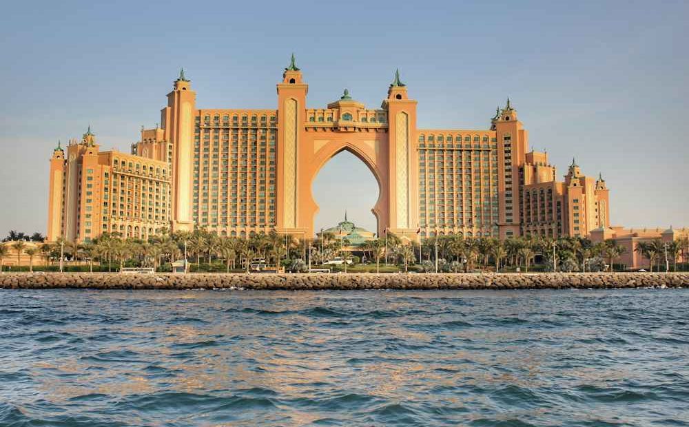 Atlantis The Palm glowing at sunset over the water